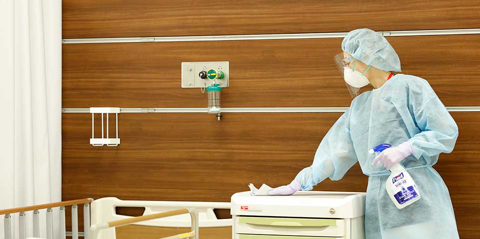 #09 Main visual / Masked nurse disinfecting a hospital room