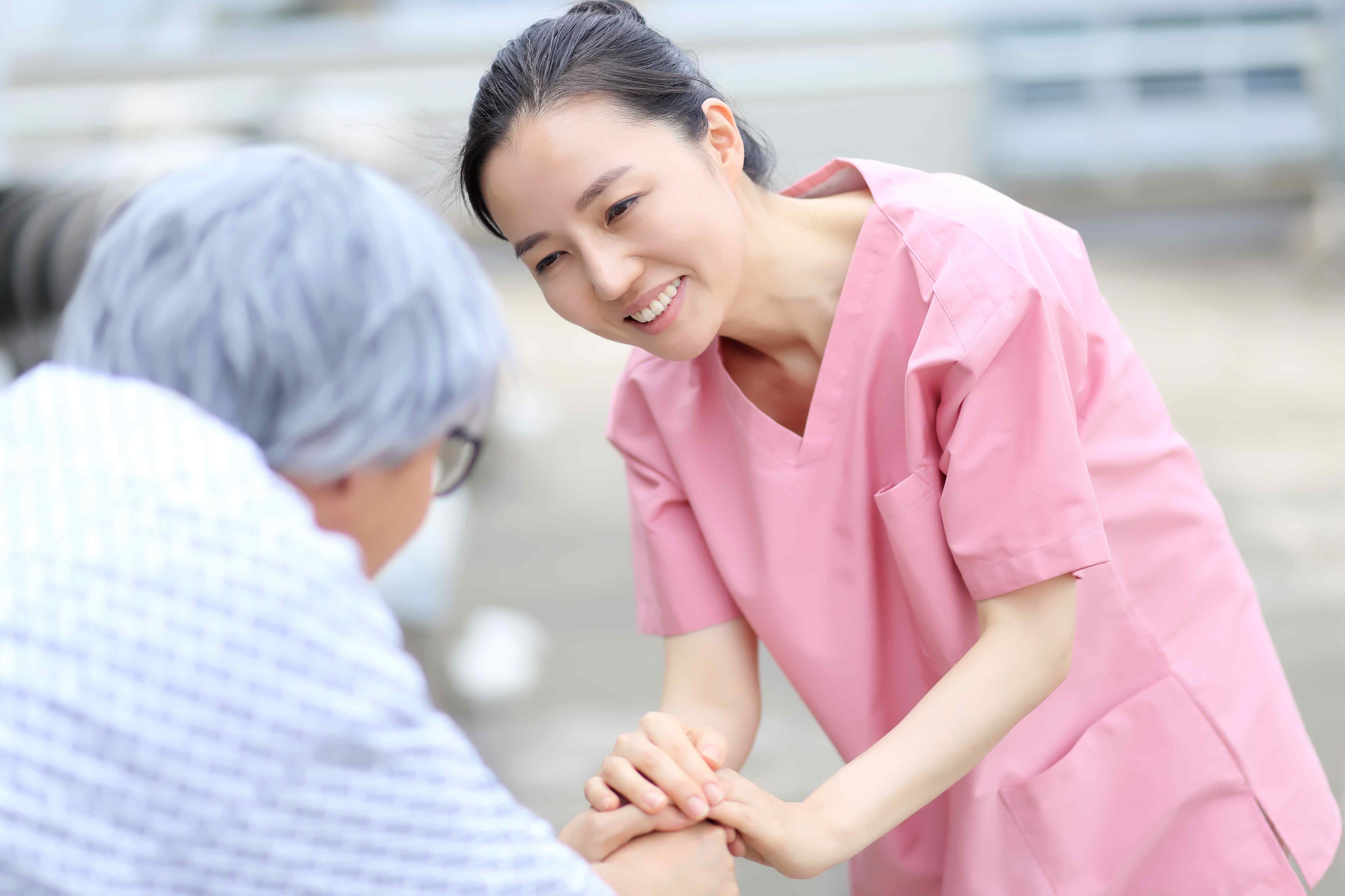 Hospital Care Solution Businenn Image / Nurse smiling at a patient