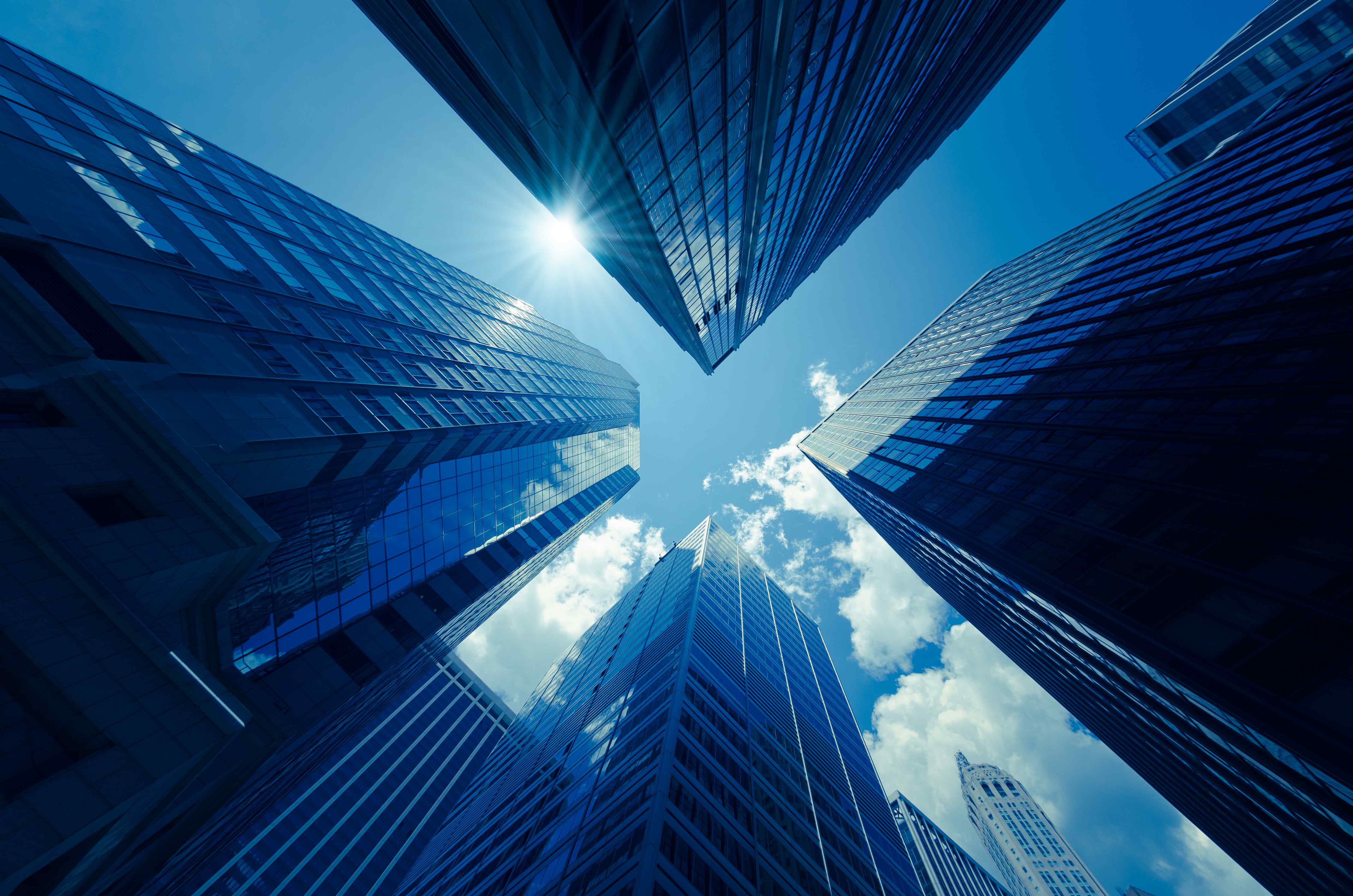 IR Information Top Image / Blue sky looking up from a skyscraper district